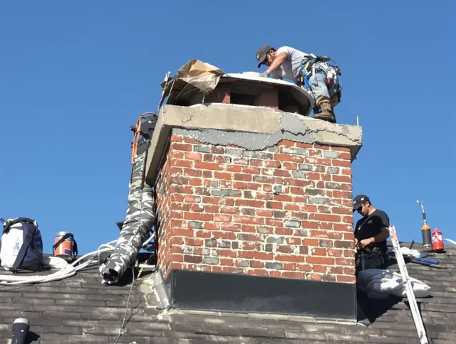 Kingston Chimney Sweep installing a custom chimney crown in Kingston, MA