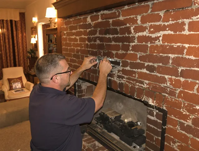 Kingston Chimney Sweep expert fixing a fireplace in Kingston, MA